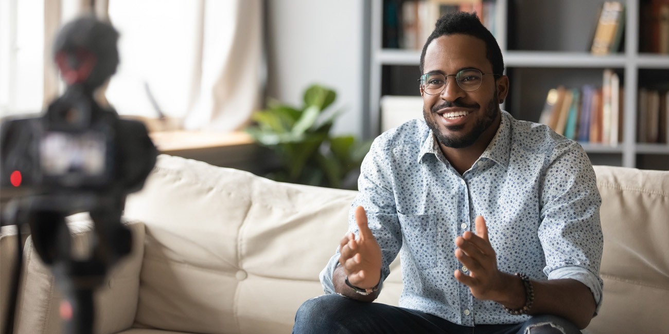 African American man giving a presentation using a webcam to maintain social distancing