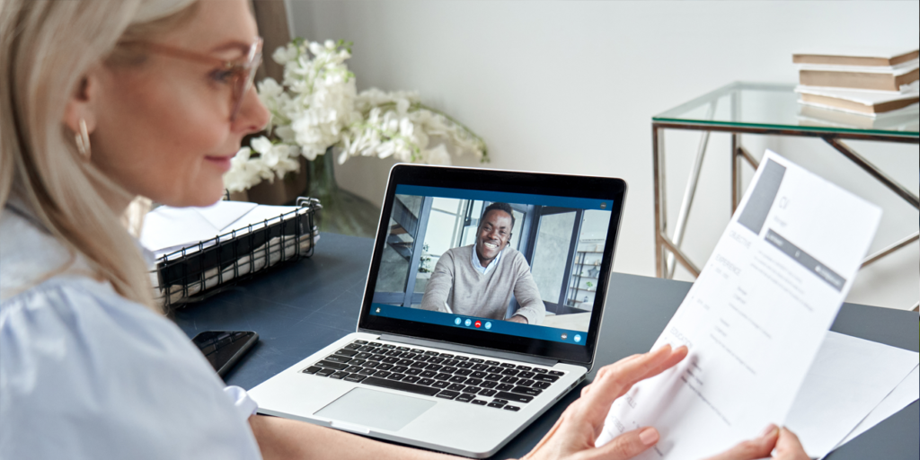 Female hr reading resume during online virtual job interview by video call